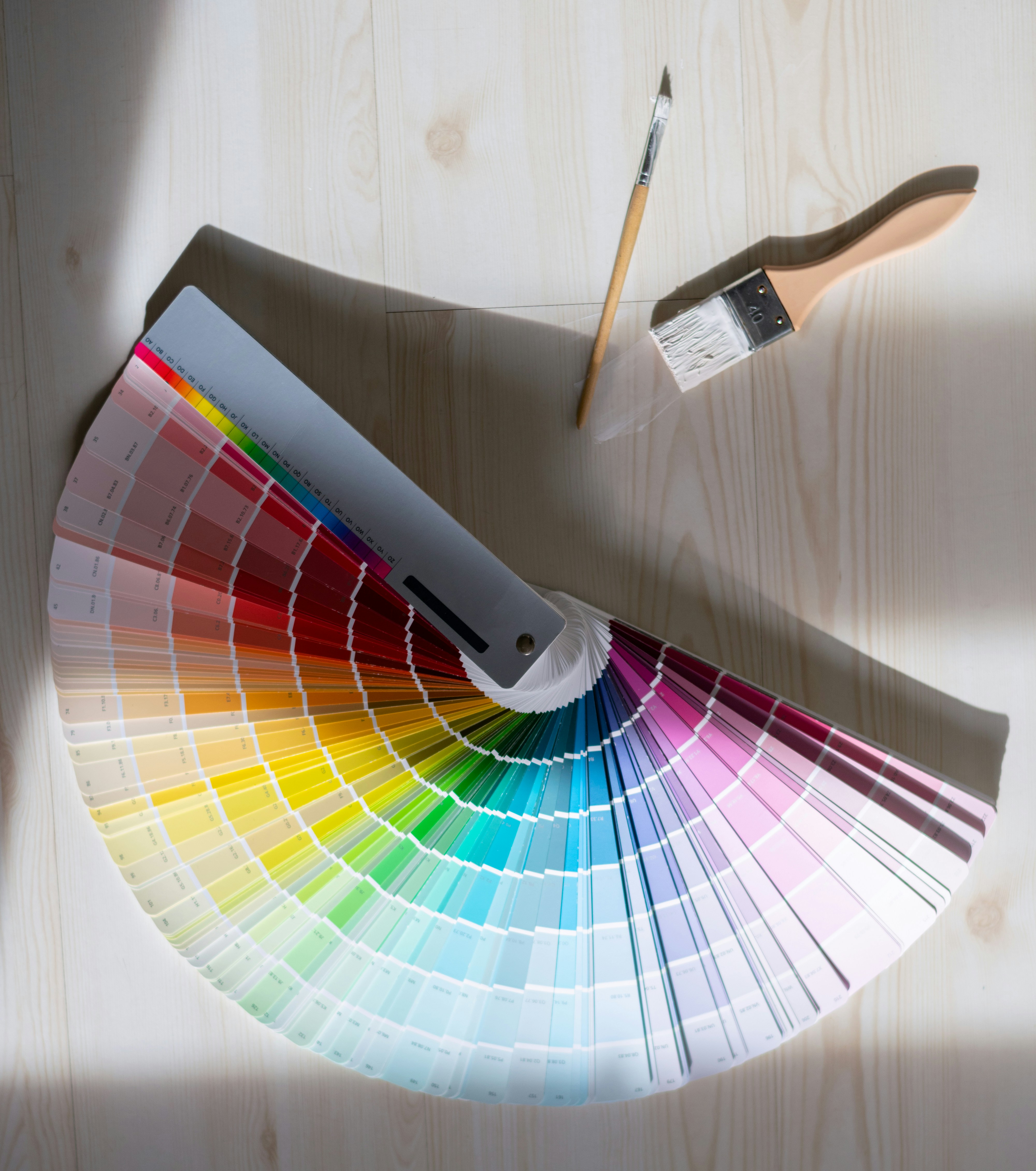 Paint brush and colour swatches on floor